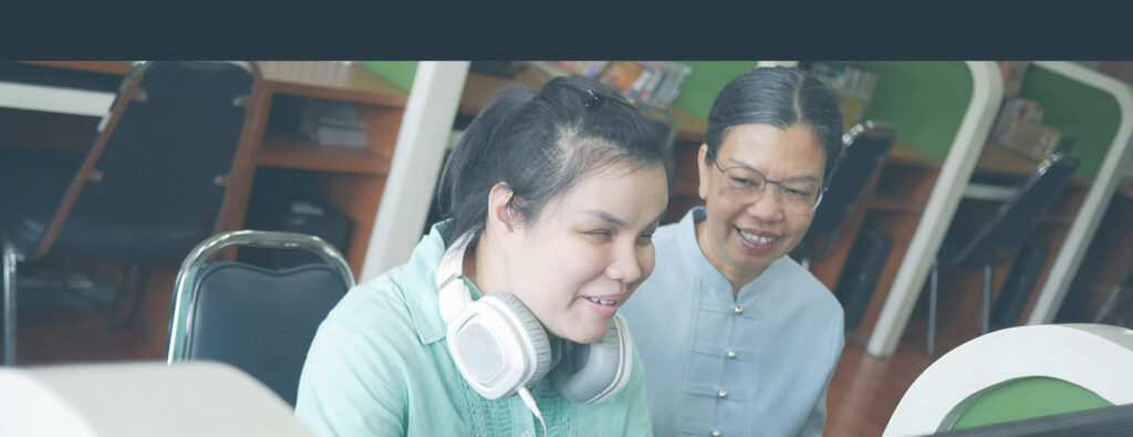 Visually Impaired woman with headphones working with a support worker